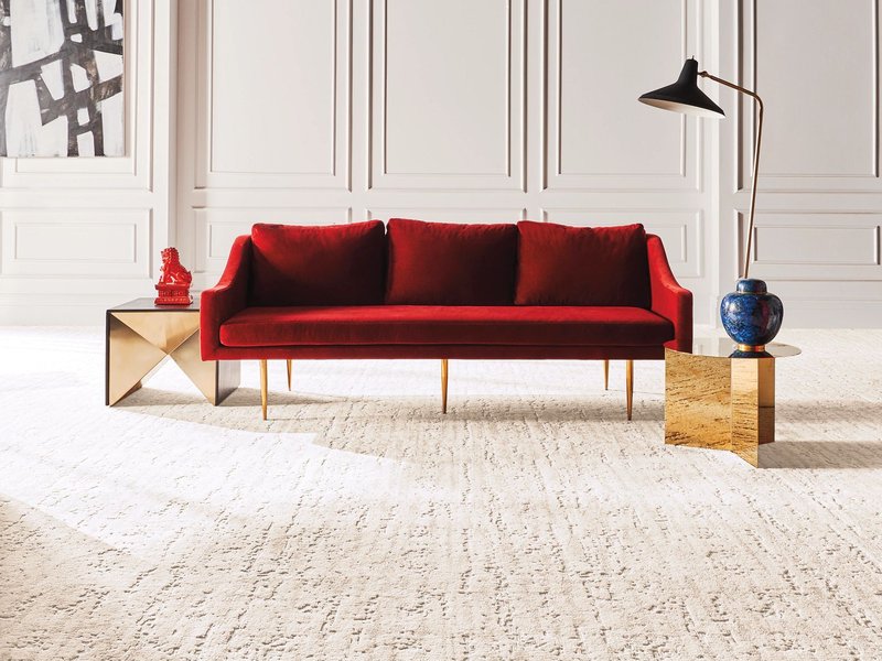 red couch on white carpet
