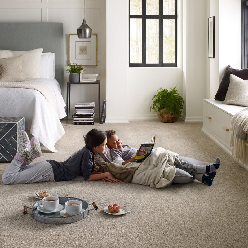 Children reading book on the floor