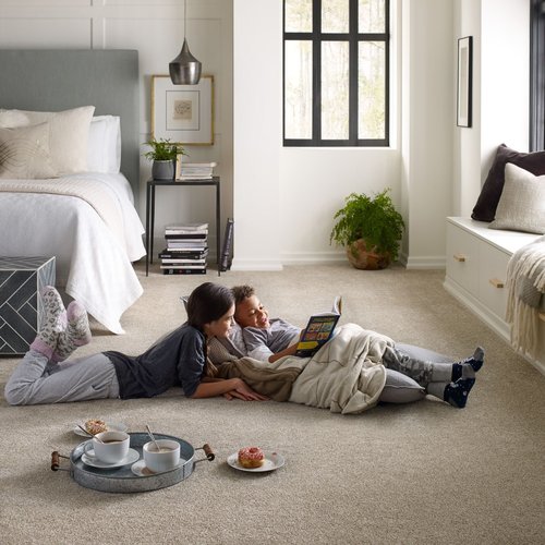 Children reading book on the floor